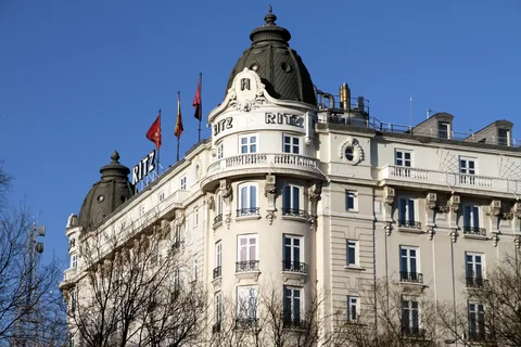 The landmark Ritz hotel in Madrid beneath a clear blue sky