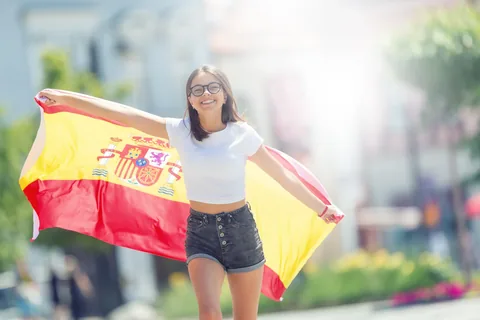 A welcoming visitor holding the Spanish flag